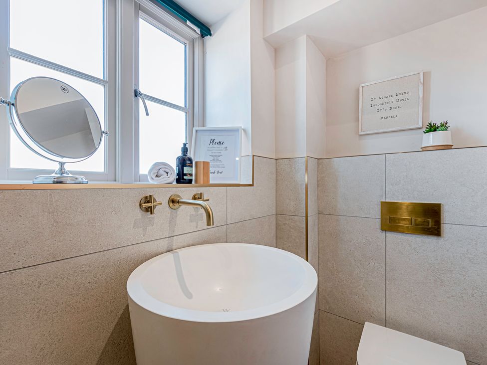A bathroom with a mirror and sink at Fairvale House