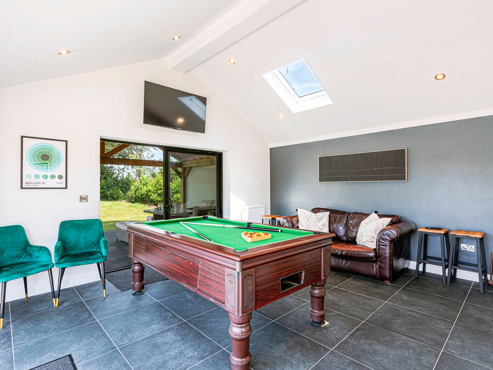 A game room with a pool table and sofa at Fairvale House