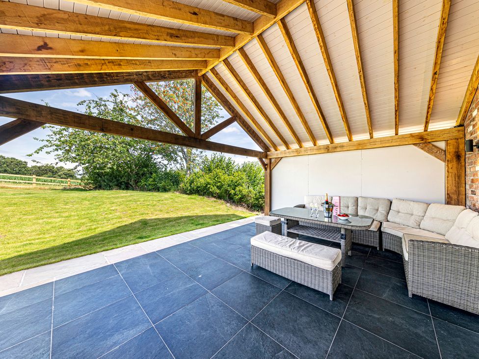 An outdoor seating area with a table and couch at Fairvale House