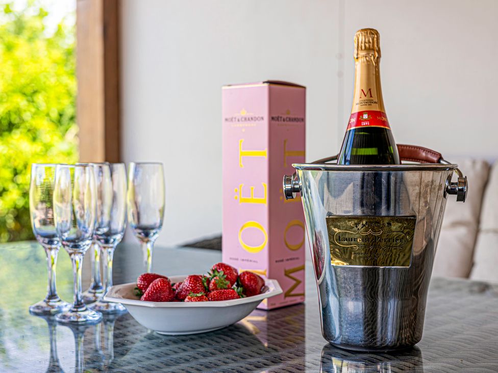 An ice bucket with champagne, glasses, and strawberries at Fairvale House