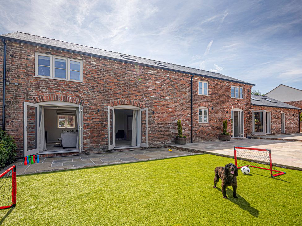 An outdoor area with a dog and goalposts at Fairvale House