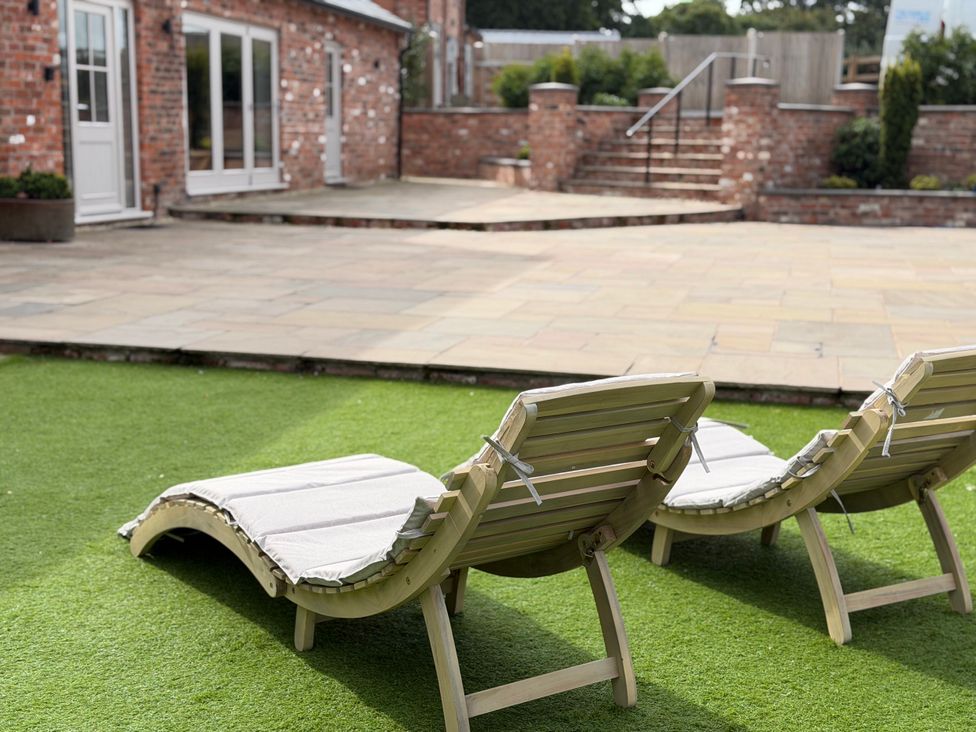 Sun loungers on artificial grass in an outdoor area at Fairvale House Northwich