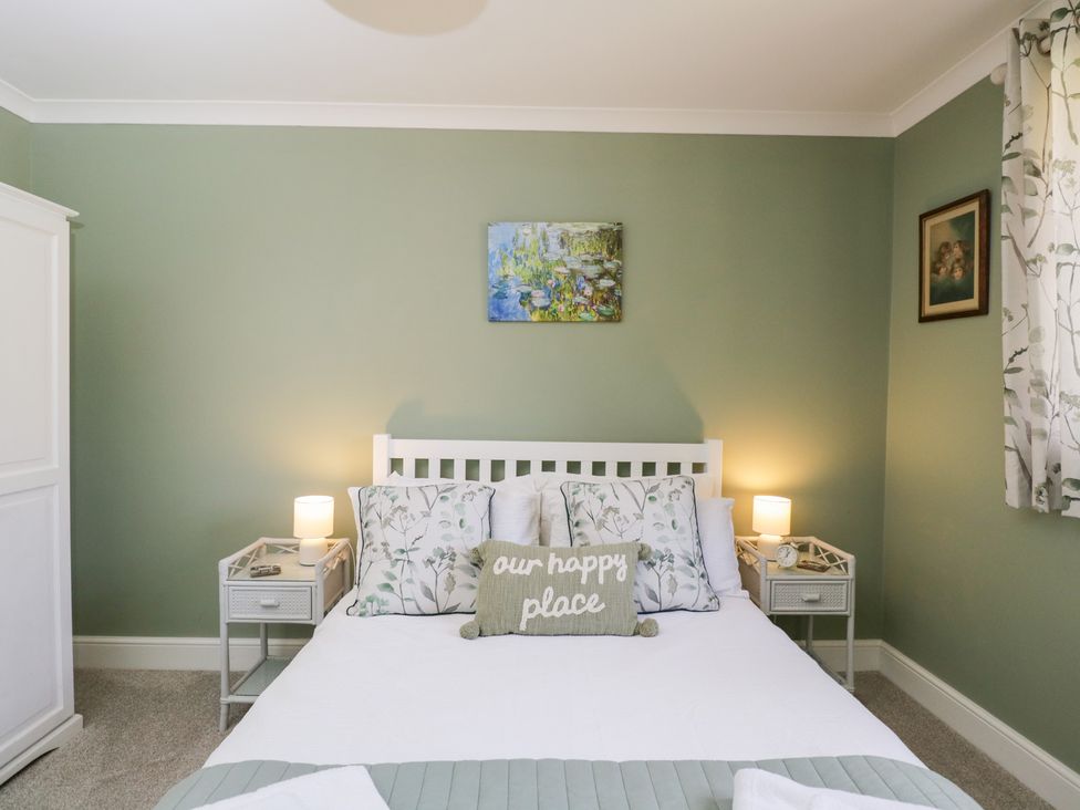 A bedroom with a bed and decorative elements at The Old Byre in Woodfalls