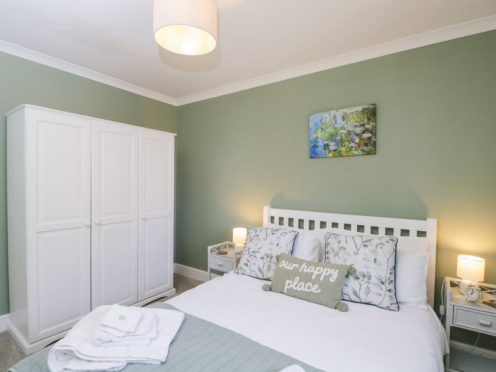 A bedroom with a bed and wardrobe at The Old Byre in Woodfalls