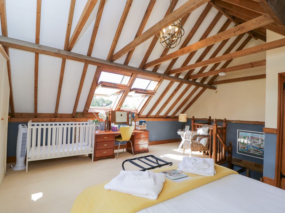 A bedroom with a bed and furniture at The Old Byre in Woodfalls