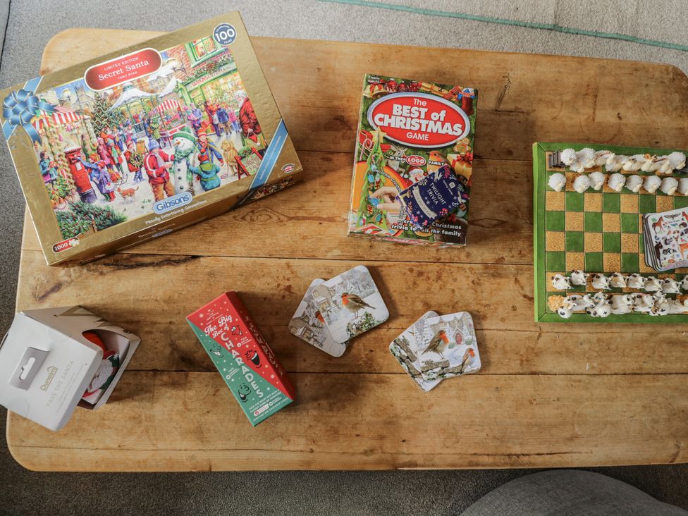 A coffee table with games and coasters at The Old Byre in Woodfalls