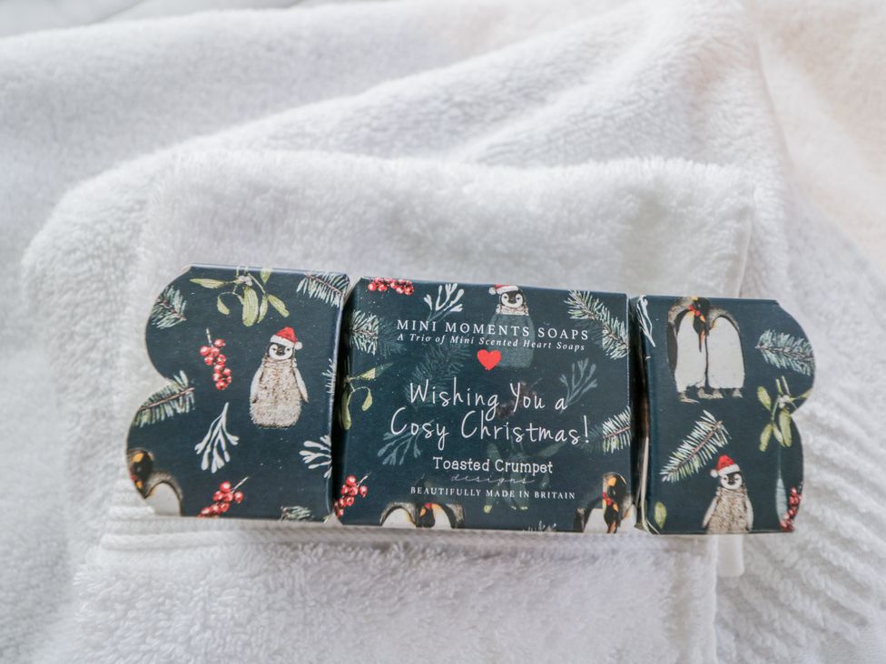 A soap package with Christmas greeting on a white towel at The Old Byre in Woodfalls