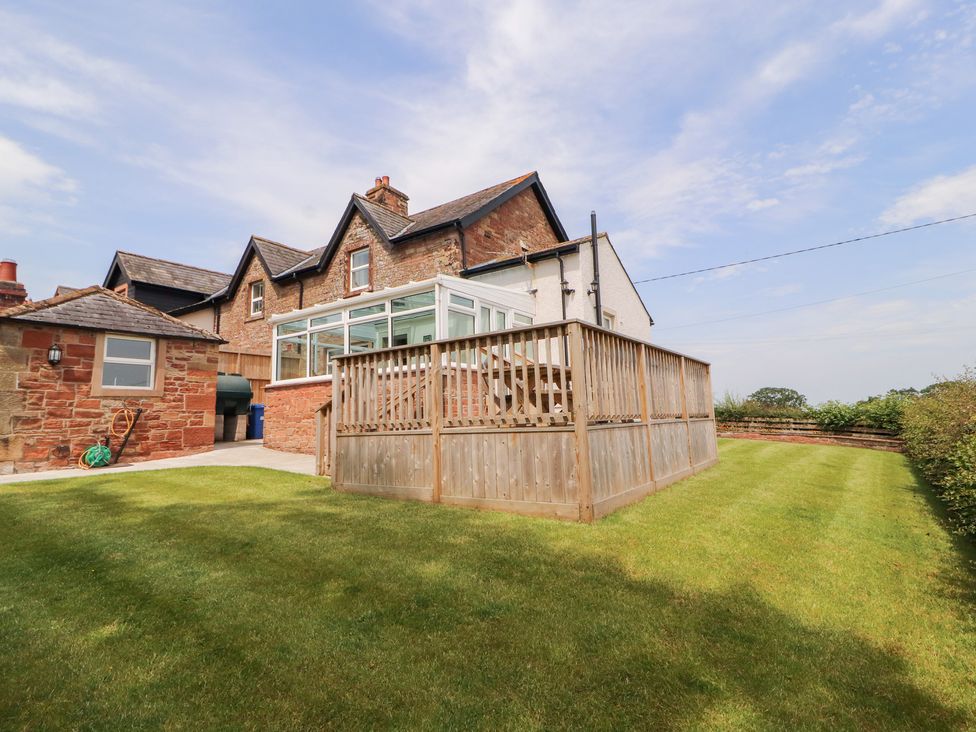 A house with a garden and deck area at Rose Bank Cottage in Dalston