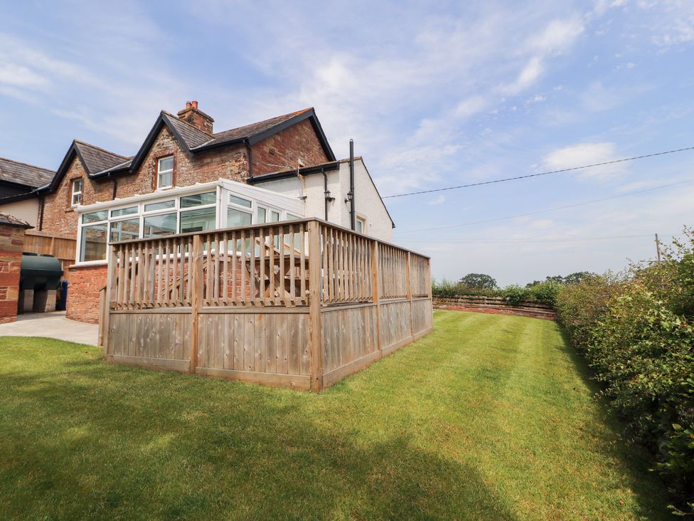 An outdoor area featuring a garden and wooden fence at Rose Bank Cottage in Dalston