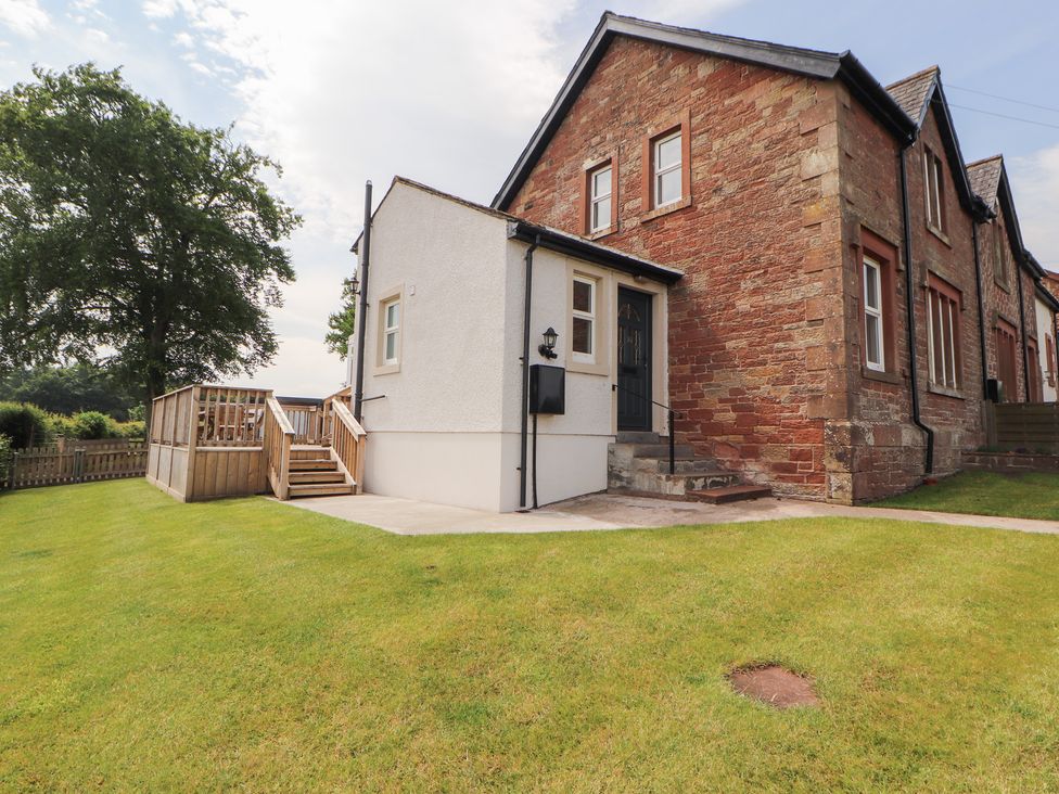 A house with a lawn and steps at Rose Bank Cottage in Dalston