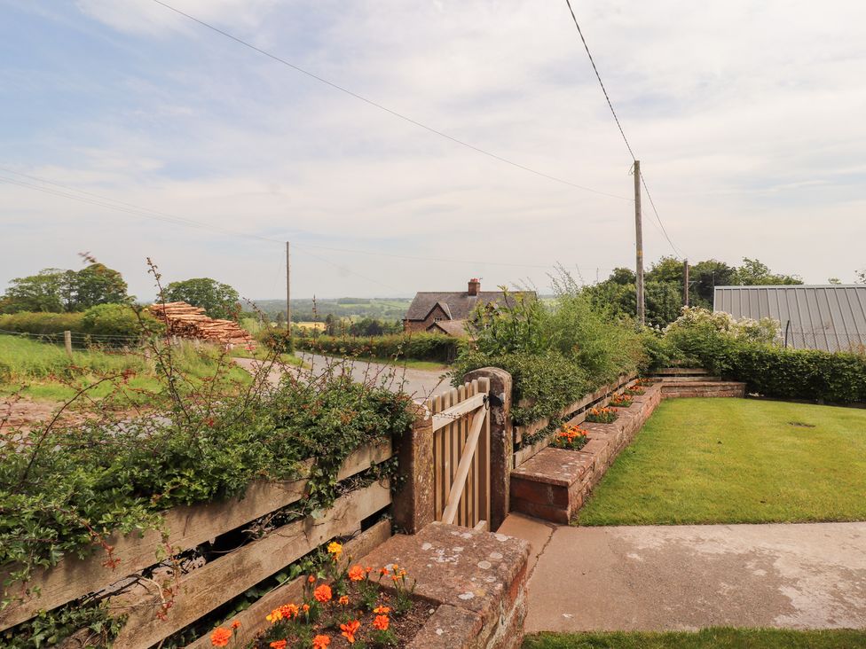 An outdoor view with a gate and garden at Rose Bank Cottage in Dalston