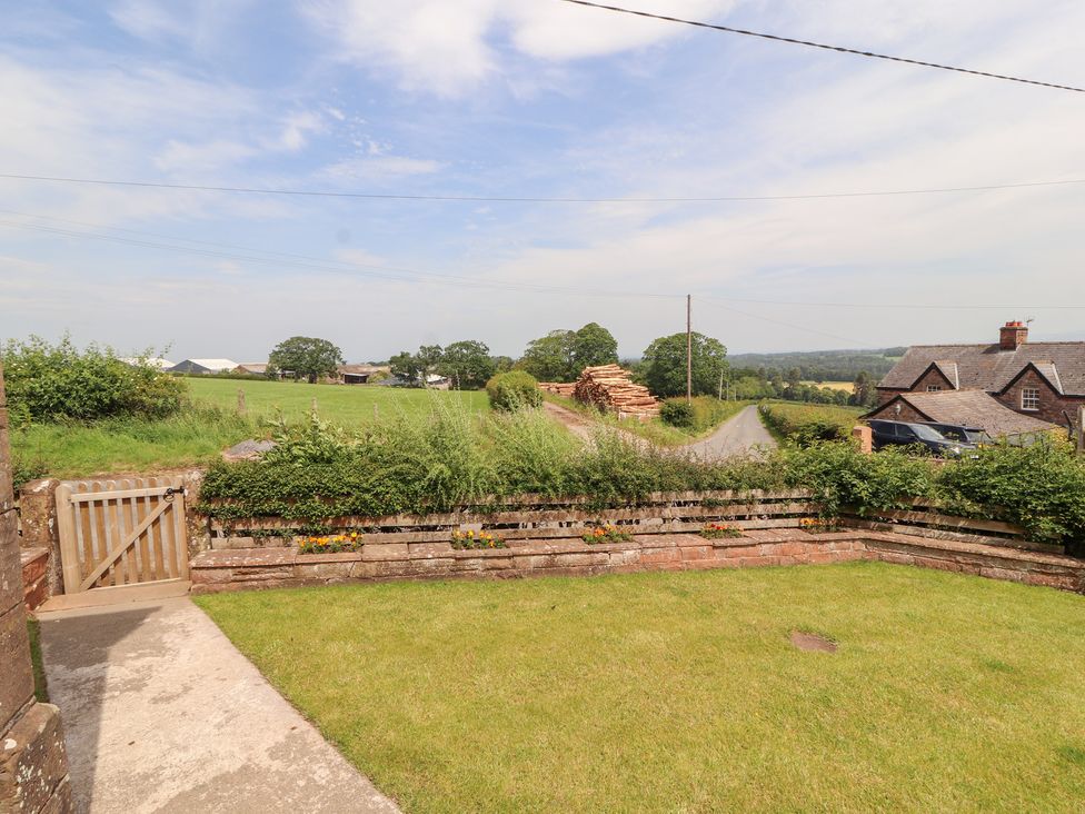 A garden with gate and grass at Rose Bank Cottage in Dalston