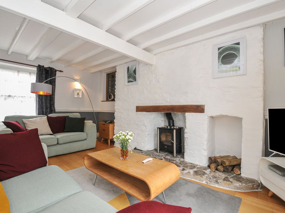 A living room with a sofa and coffee table at 3 River View in Looe