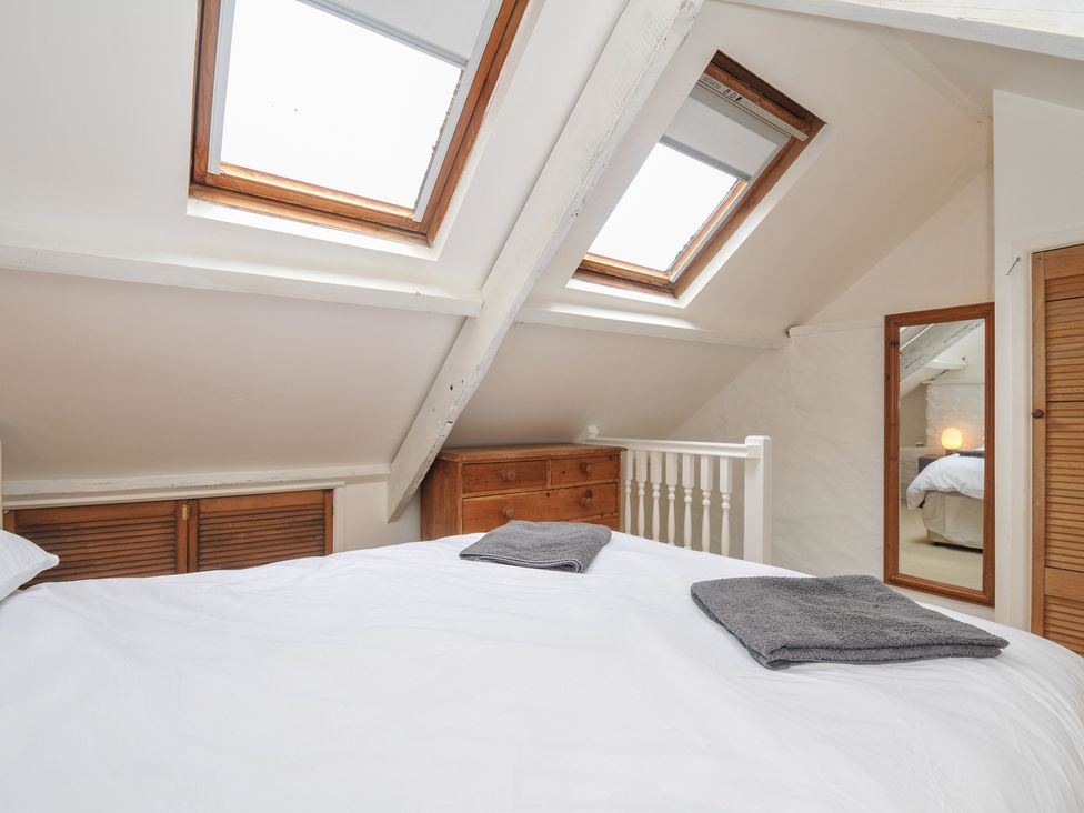 A bedroom with skylights and a bed at 3 River View, Looe