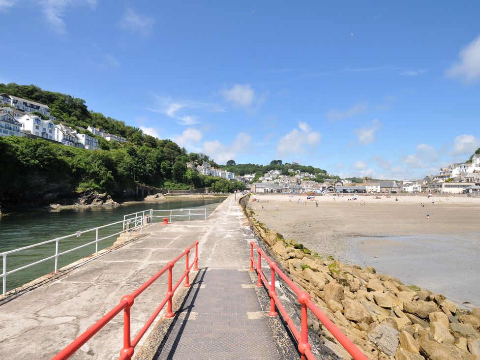 A pier with buildings and beach at 3 River View Looe