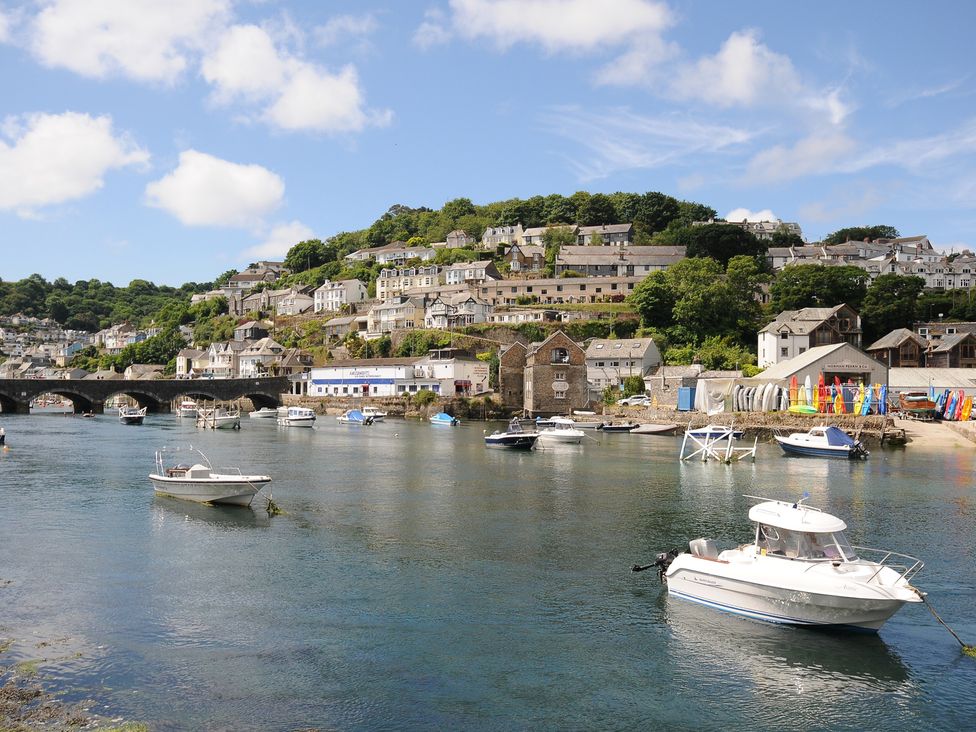 A view of a harbor with boats and houses at 3 River View in Looe