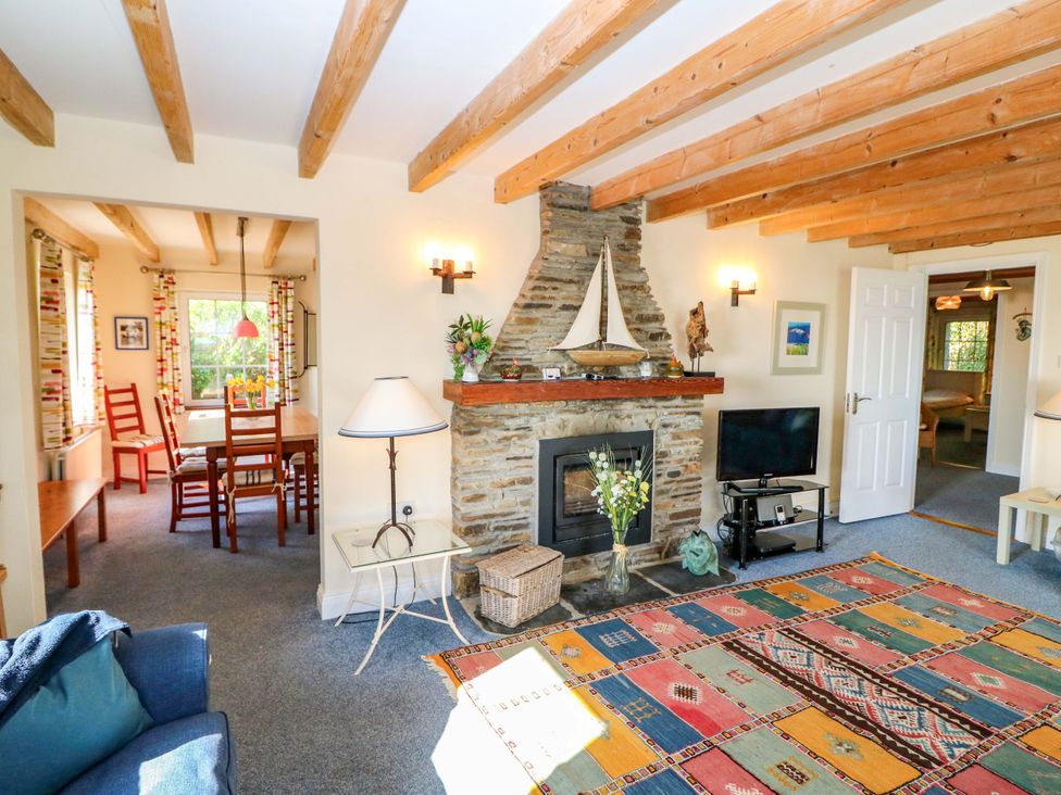 A living room with a fireplace and sofa at Whispering Pines in Durrus, County Cork