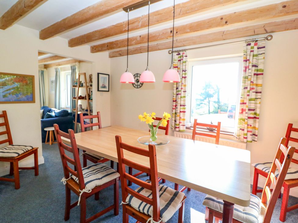 A dining room with a table and chairs at Whispering Pines in Durrus, County Cork
