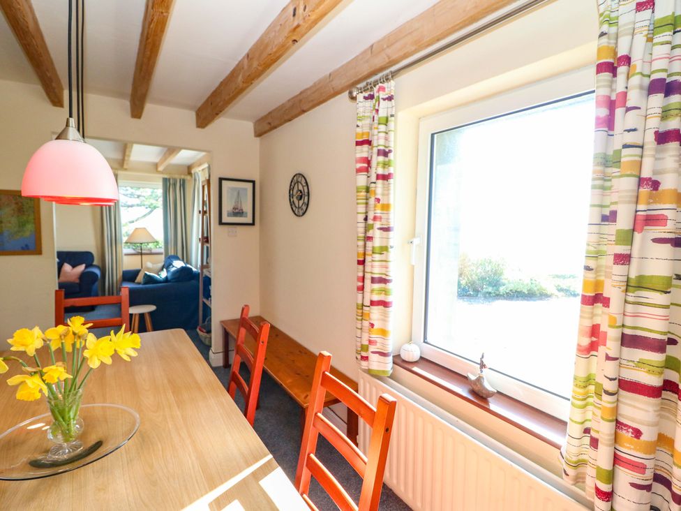 A dining room with a table and chairs at Whispering Pines in Durrus, County Cork