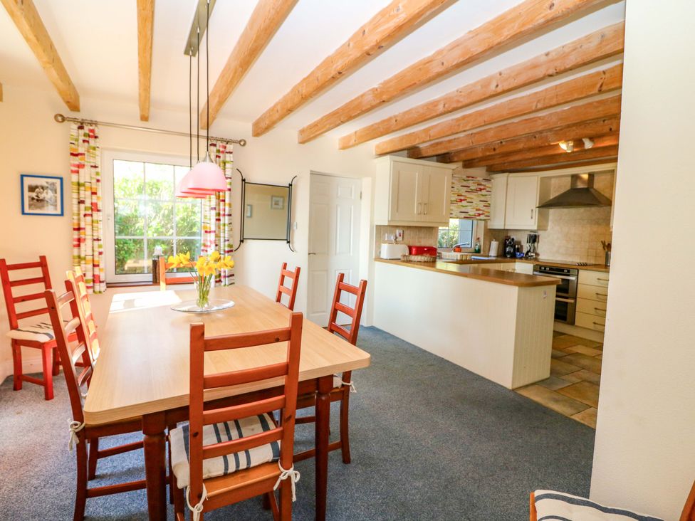 A dining room with a table and chairs at Whispering Pines in Durrus, County Cork
