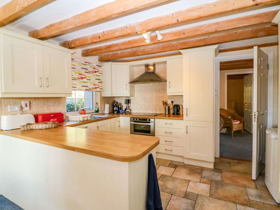 A kitchen with cabinets, countertop, stove, and oven at Whispering Pines in Durrus, County Cork