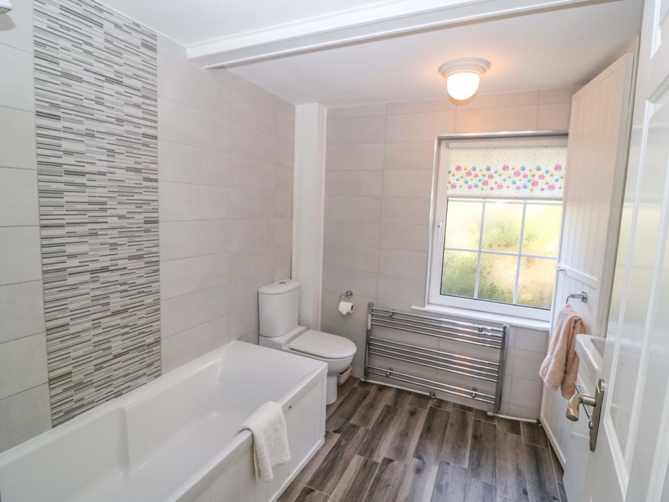 A bathroom with a bathtub and toilet at Whispering Pines in Durrus, County Cork