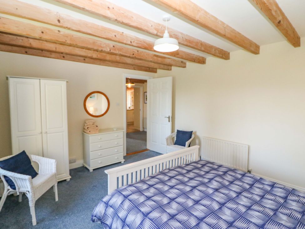 A bedroom with a bed and wardrobe at Whispering Pines, Durrus, County Cork