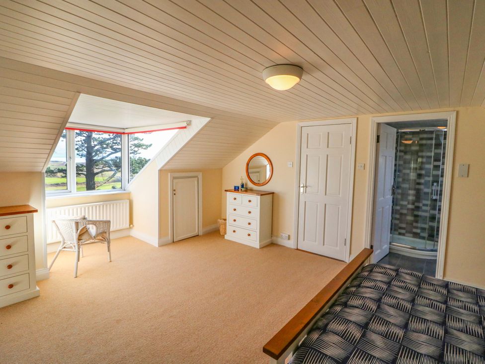 A bedroom with a bed and dressing table at Whispering Pines in Durrus, County Cork