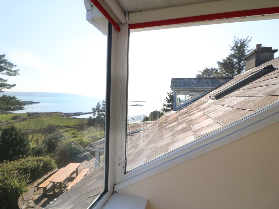 A view of the ocean and landscape from a window at Whispering Pines, Durrus, County Cork
