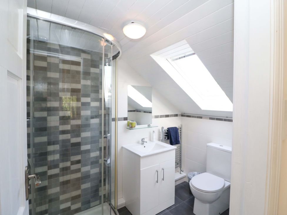 A bathroom with a shower, sink, and toilet at Whispering Pines, Durrus, County Cork