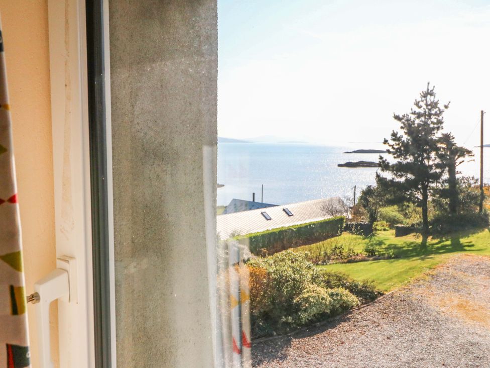 A view of the sea and landscape from a window at Whispering Pines in Durrus, County Cork