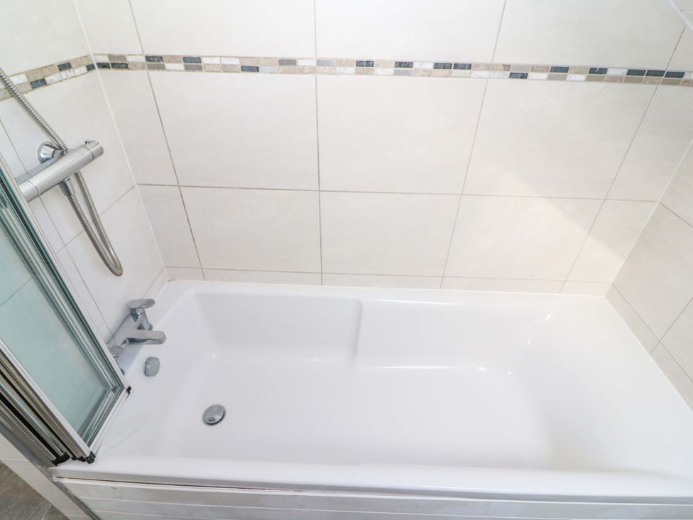 A bathtub with a shower attachment at Whispering Pines in Durrus, County Cork