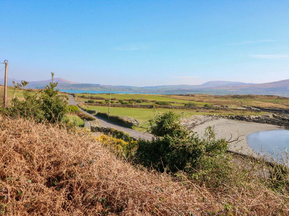 A landscape with a road and water in the background at Whispering Pines, Durrus, County Cork