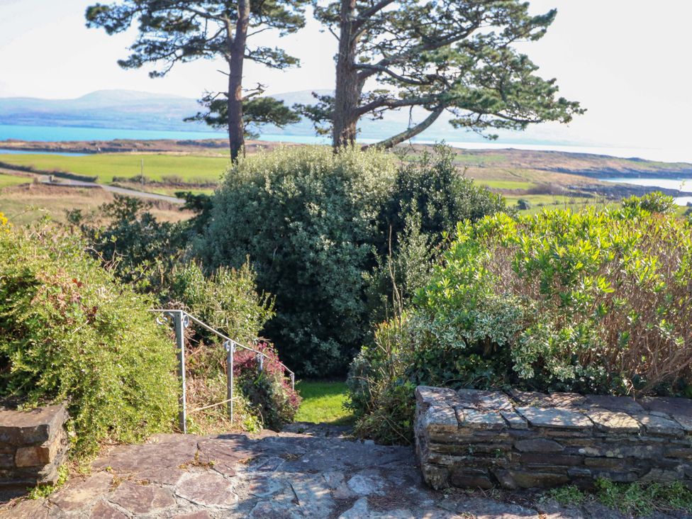 A garden with stone steps leading down to green grass at Whispering Pines in Durrus, County Cork