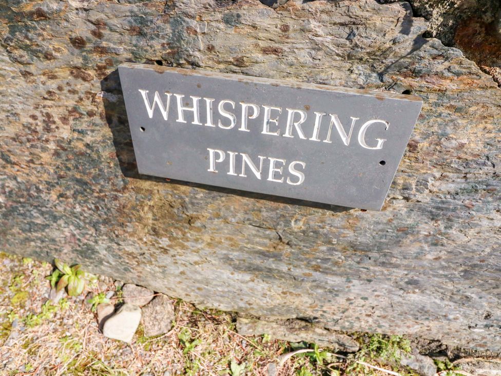 A sign displaying 'Whispering Pines' on a rock at Whispering Pines in Durrus, County Cork