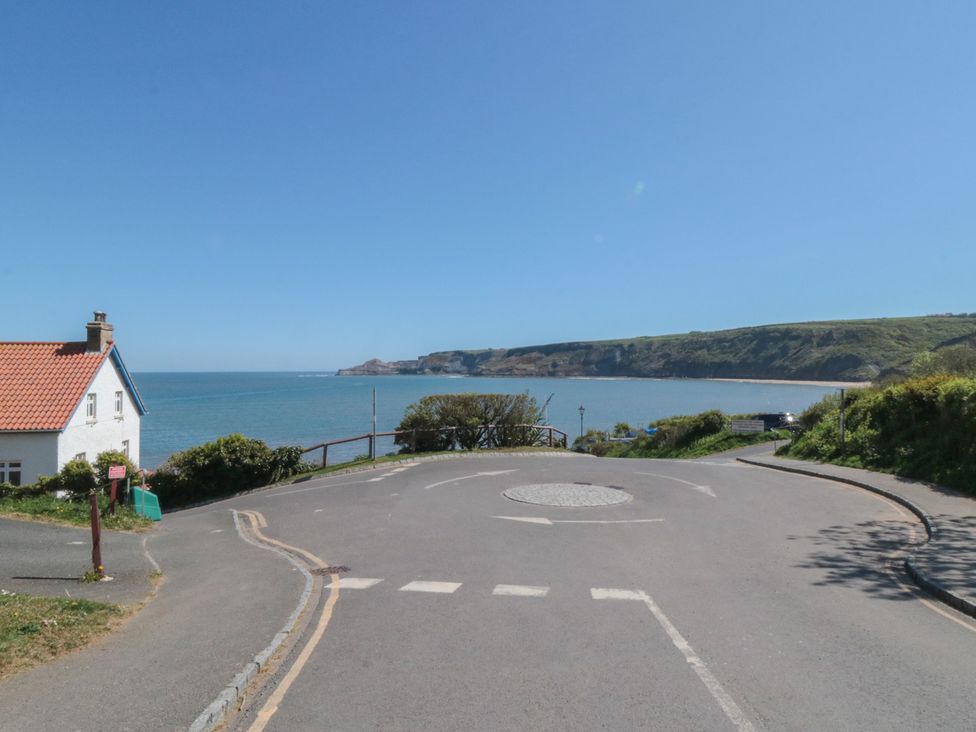 A view of the sea with a house and road at Mayflower Lodge, Runswick Bay near Staithes