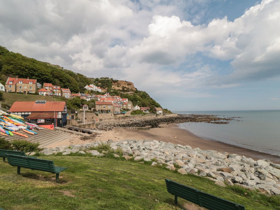 A beach with boats and houses at Foxglove Lodge Runswick Bay near Staithes