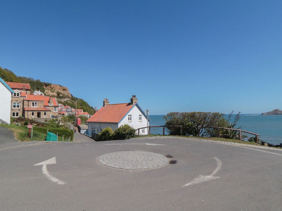 A coastal scene with houses and a roundabout at Rose Lodge Runswick Bay near Staithes