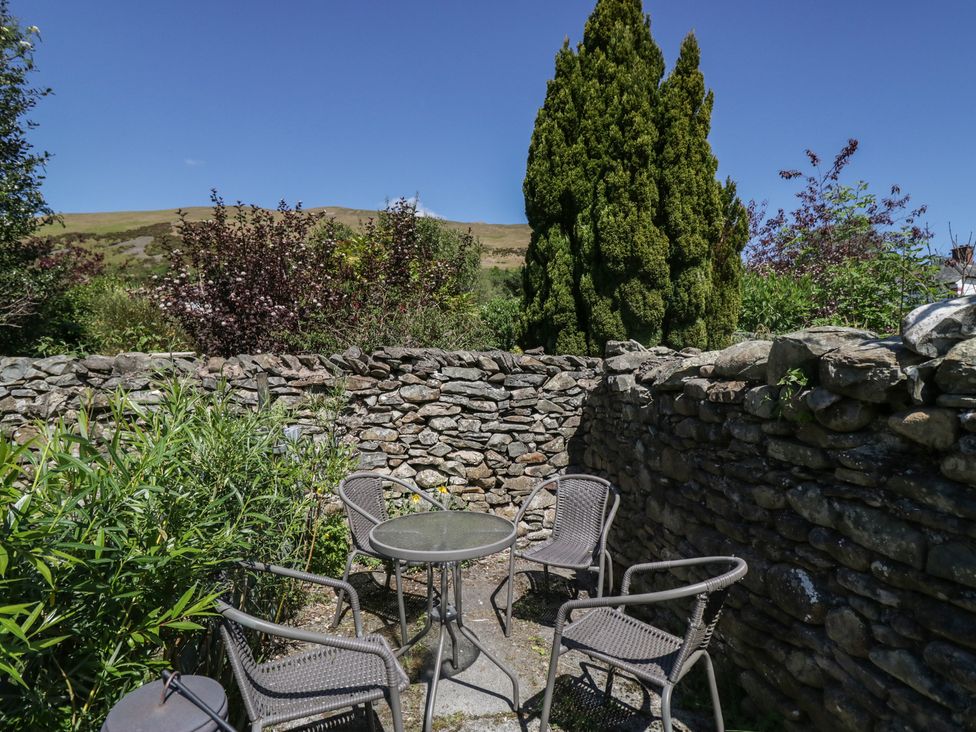 An outdoor seating area with table and chairs at Badgers, Sedbergh, Yorkshire Dales