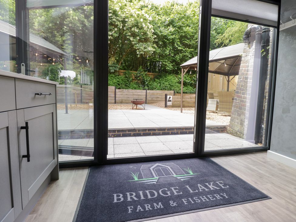 A view from inside looking at a patio area at The Tunnel at Bridge Lake Farm and Fishery in Chacombe