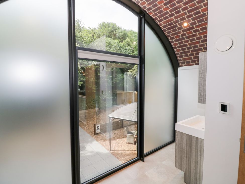 A bathroom with a sink and window at The Tunnel at Bridge Lake Farm and Fishery in Chacombe