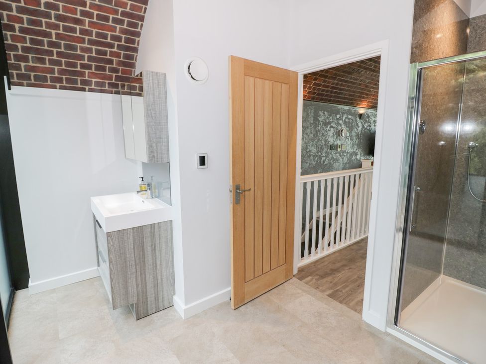 A bathroom with a shower and sink at The Tunnel at Bridge Lake Farm and Fishery Chacombe