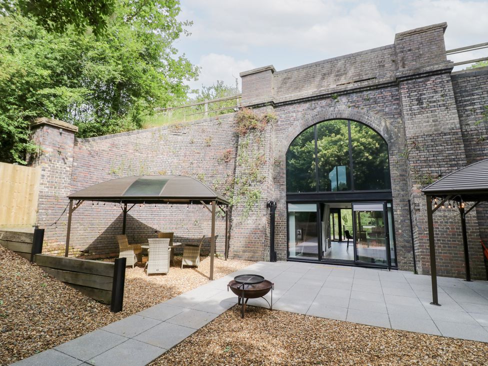 An outdoor area with a gazebo and seating at The Tunnel at Bridge Lake Farm and Fishery Chacombe