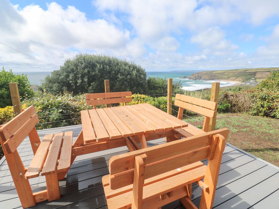 A wooden table and benches overlooking the ocean at Shearwater 