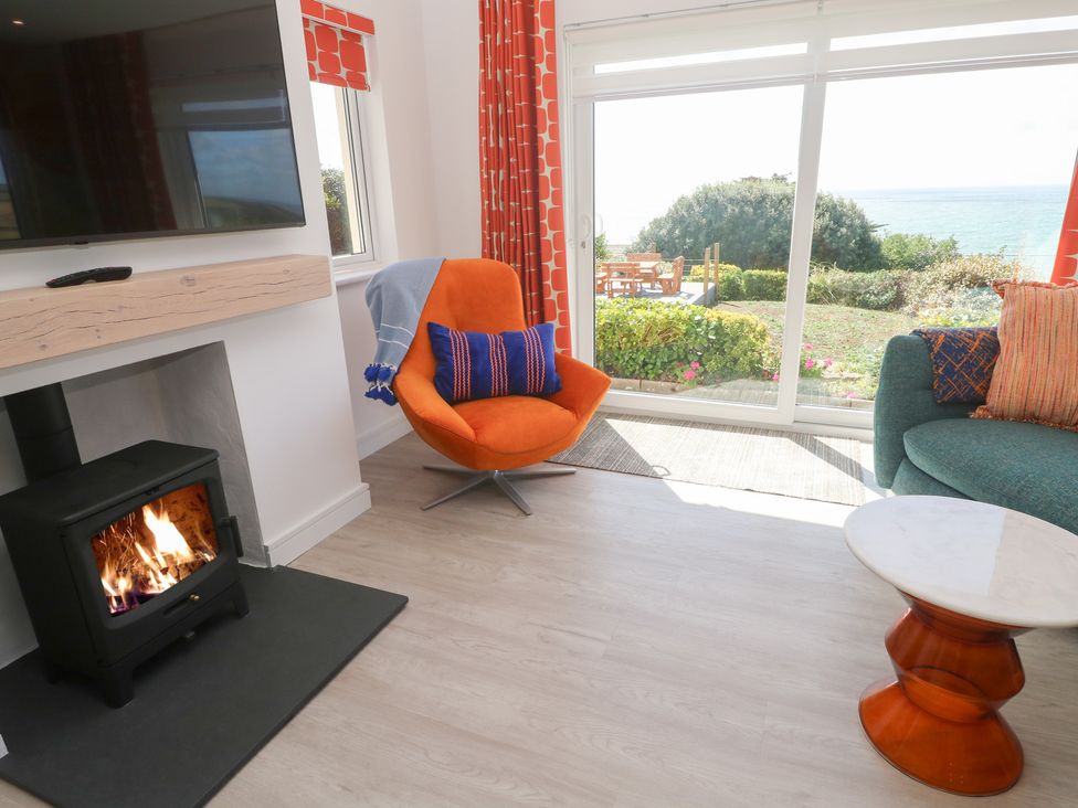 A living room with a fireplace and furniture at Shearwater