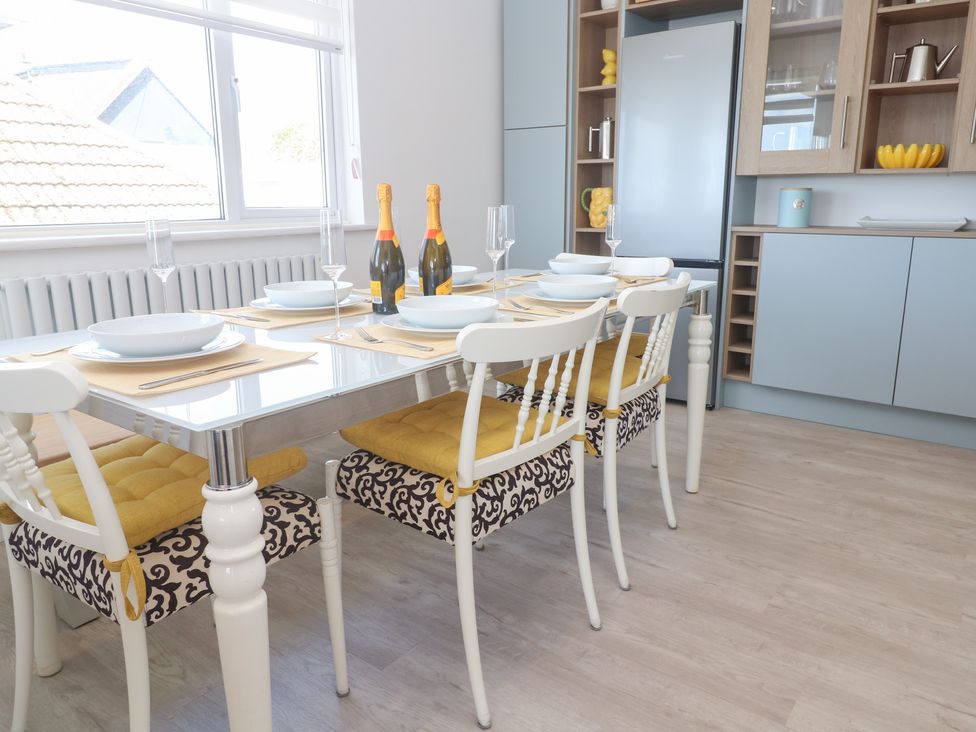 A dining room with a table set for six at Shearwater