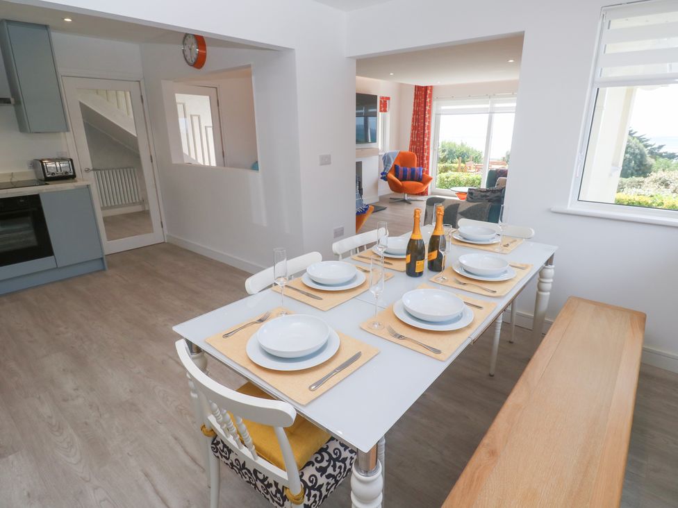 A dining table with settings and champagne bottles at Shearwater