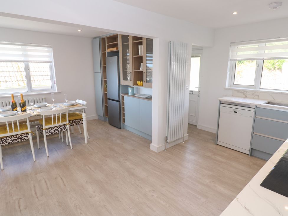 A kitchen with a dining table and chairs at Shearwater