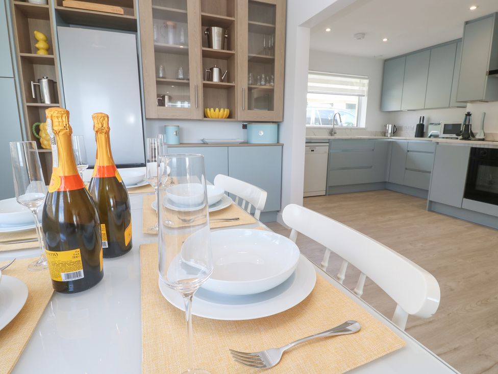 A dining room with champagne bottles and tableware at Shearwater
