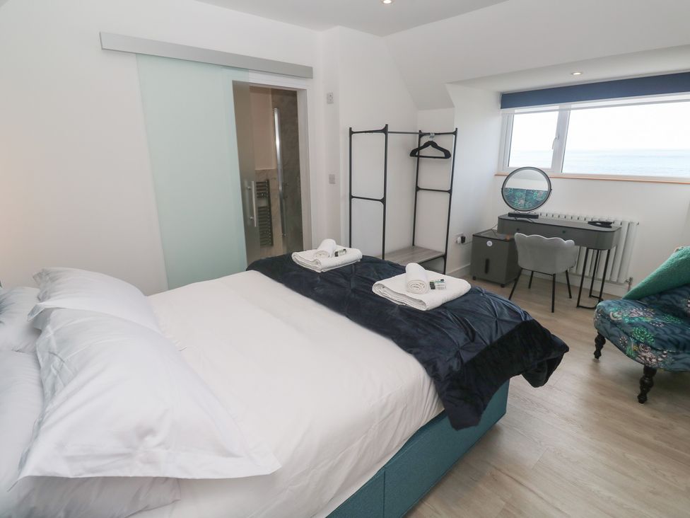 A bedroom with a bed and desk at Shearwater